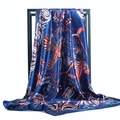 Elegant navy blue satin scarf with red paisley and bird prints on a black metal frame - Navy Blue