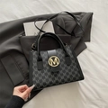 Elegant black monogram tote bag with gold M logo and adjustable shoulder strap - Black