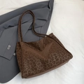 Brown leopard print shoulder tote bag displayed on white fabric with a grey blazer - Brown