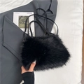 Chic black faux fur shoulder bag with leather strap on a stylish minimalist background - Black