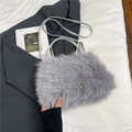 Light gray faux fur handbag with a slim adjustable shoulder strap on a chic fabric surface - Gray