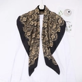 Classic black and gold paisley silk satin square scarf displayed on an elegant hanger - Black Gold