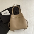 Minimalist khaki leather bucket bag with gold metal clasp and drawstring detailing - Khaki