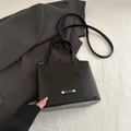 Minimalist black matte leather bucket bag with top handles and adjustable shoulder strap - Black