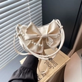 Elegant off-white satin bow shoulder bag with pearl chain and floral silver charms - White