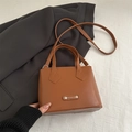 Brown faux leather crossbody bucket bag with dual handles and adjustable strap - Tan