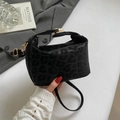 Minimalist black leopard print crossbody bag with gold hardware and a top handle - Black
