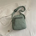 Sage green corduroy crossbody bag with adjustable shoulder strap and front zipper pocket - Green