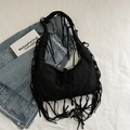 Black bohemian hobo shoulder bag with long fringes and wide strap on white fabric - Black