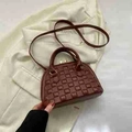 Structured burgundy shell tote bag with checkered embossing and dual top handles - Brown