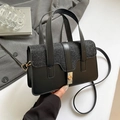 Fashionable black crossbody bag with sequin panel and gold twist-lock on suit background - Black