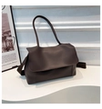 Detail of a dark brown PU leather tote bag with a matte finish on a minimalist white stand - Coffee