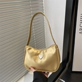 Metallic gold hobo underarm bag featuring a rhinestone heart and bow embellishment - Gold