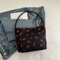 Black nylon tote bag featuring vibrant red cherry prints with a minimalist shoulder strap - Black