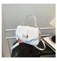 Detail of white lychee texture handbag with elegant gold metal buckle and top handle - White
