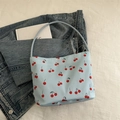 Light blue tote bag with cherry print on denim background for casual style - Blue