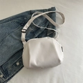 Minimalist white nylon crossbody bag with adjustable strap on a denim jacket background - White
