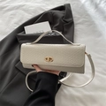 Chic cream woven square bag with gold CD buckle on white bedding and grey blazer - White