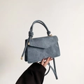 Denim blue crossbody bag with a knot handle detail and matching shoulder strap - Blue
