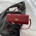 Red woven leather crossbody bag with CD gold metal buckle on a minimalist background - Red