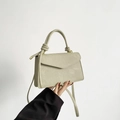 Chic light beige rectangular crossbody bag with top handle and decorative metal knots - Green