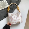 Elegant mini bag with pink butterfly embroidery and a unique wooden bead ring handle - Bow Pink