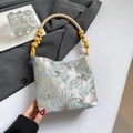 Retro underarm bag with blue floral jacquard fabric and yellow beaded handle detail - Bow Blue
