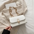 Chic white crossbody bag with gold chain strap and metal clasp on beige blazer - White
