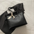 Black matte tote bag with decorative scarf and fashion print on gray blazer background - Black