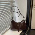 Retro deep brown hobo bag with adjustable strap and rivet buckle detail in sunlight - Brown
