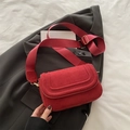 Red suede crossbody saddle bag with embossed flap and wide woven shoulder strap - Suede Red
