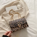 Stylish leopard print crossbody bag with gold chain strap and oval twist lock closure - Leopard Brown