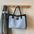 Light blue quilted tote bag with colorful embroidery and black straps for casual wear - Blue