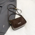 Detailed macro view of brown leopard crossbody bag with suede finish and gold hardware - Brown
