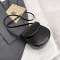 Minimalist black saddle crossbody bag with adjustable strap on neutral background - Black