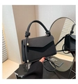 Detail of black woven texture handbag with knotted handle and elegant metal accents - Black