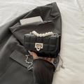 Black quilted crossbody bag with pearl handle and silver U-shaped metal lock closure - Black