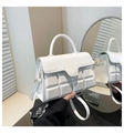 Detail of white handbag with chocolate grid texture and light gold hardware hooks - White