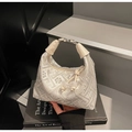Detail of white embroidered handbag with tassel decor on design book background - Off White