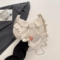 Beige pleated cloud bag featuring pearl chain and floral charm with metal strap - White