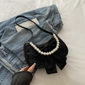 Elegant black pleated shoulder bag featuring a large bow and decorative pearl strap accent - Black