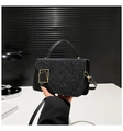 Detail of black glitter shoulder bag with golden geometric clasp and leather handle - Black