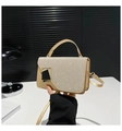Detailed view of champagne gold sequined handbag with black gold geometric buckle - Gold