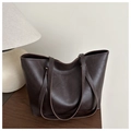 Detailed view of deep brown faux leather tote bag with elegant embossed gold lettering - Brown
