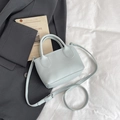 Light blue lychee pattern bucket bag with adjustable strap on a grey blazer - Blue Without Charm