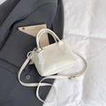 Chic off-white bucket bag with lace bow charm and pebble grain texture detail - White With Pendant