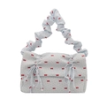 Light blue fabric shoulder bag with red bow prints and stylish ruched handle design - Blue