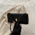 Elegant black minimalist shoulder baguette bag with a sleek gold metal lock closure - Black
