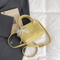 Yellow litchi leather mini bucket bag with pearl lace bow charm and adjustable strap - Yellow with Pendant