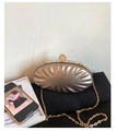 Detail of shell-textured champagne gold evening clutch with pearl and rhinestone clasp - Coffee
